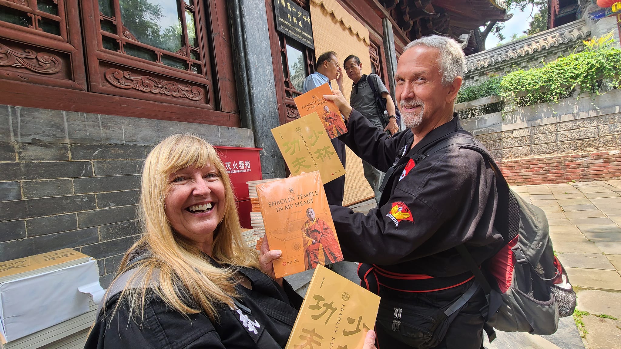 Senior Elder Masters Sharon and David Soard showing the Books our students received from Abbot Shi Yongxin at Shaolin Temple as part of our gift exchange